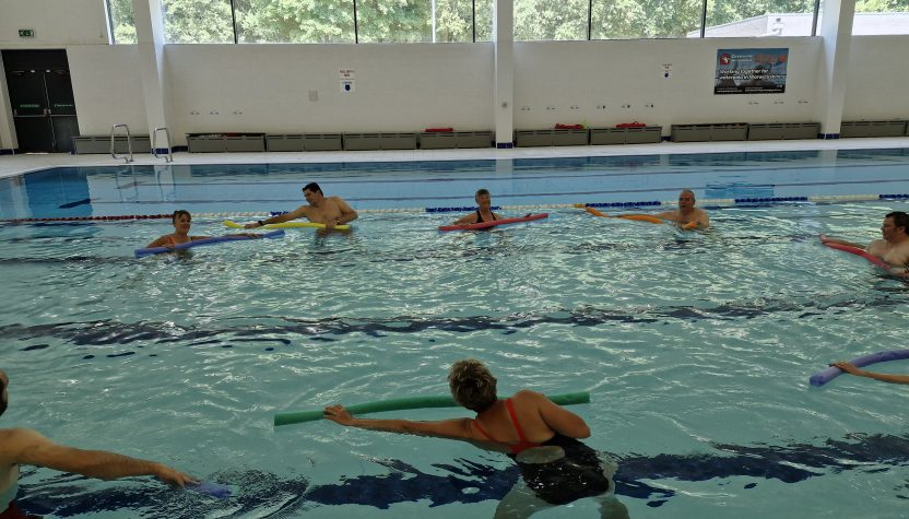 A physiotherapist leading an aquatic exercise class.